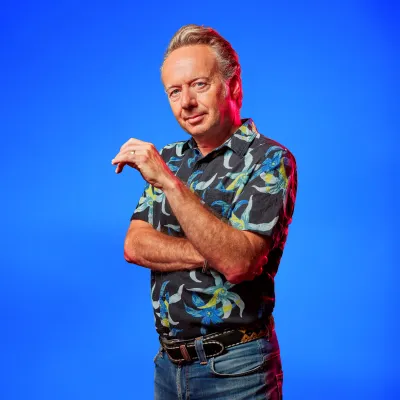 Joris Linssen poseert voor een blauwe achtergrond